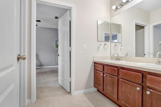 bathroom featuring tile patterned flooring and vanity