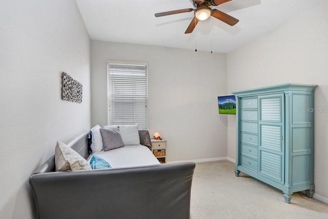 interior space with light carpet and ceiling fan