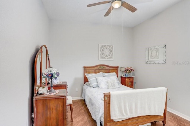 bedroom with ceiling fan and wood-type flooring