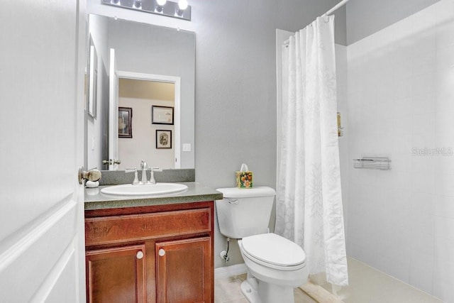 bathroom featuring toilet, vanity, tile patterned flooring, and walk in shower