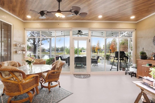 sunroom / solarium with wood ceiling and a water view