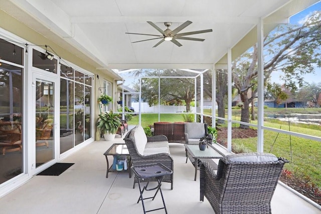 sunroom featuring ceiling fan and a healthy amount of sunlight