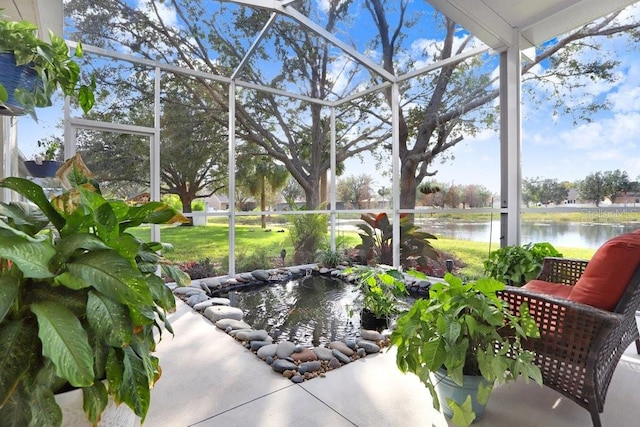 sunroom / solarium featuring a water view