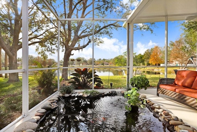 unfurnished sunroom featuring a water view