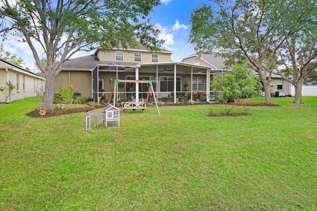 rear view of property featuring a lawn and a lanai