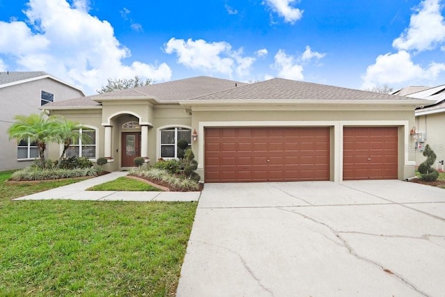 view of front of property with a front lawn and a garage