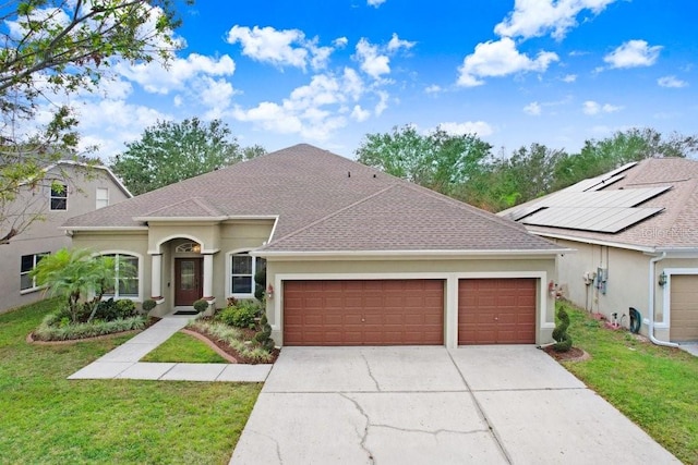 view of front of property featuring a front lawn and a garage