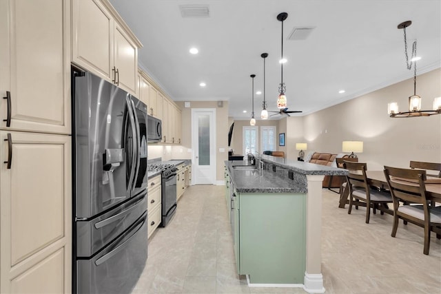 kitchen featuring decorative light fixtures, black appliances, ceiling fan with notable chandelier, dark stone countertops, and sink