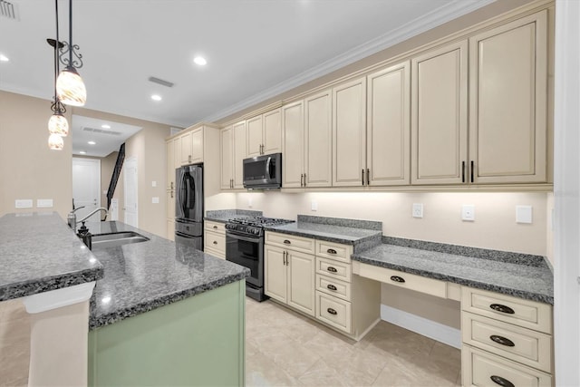 kitchen with sink, fridge, decorative light fixtures, cream cabinets, and gas stove