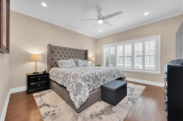 bedroom with ceiling fan, crown molding, and dark hardwood / wood-style floors