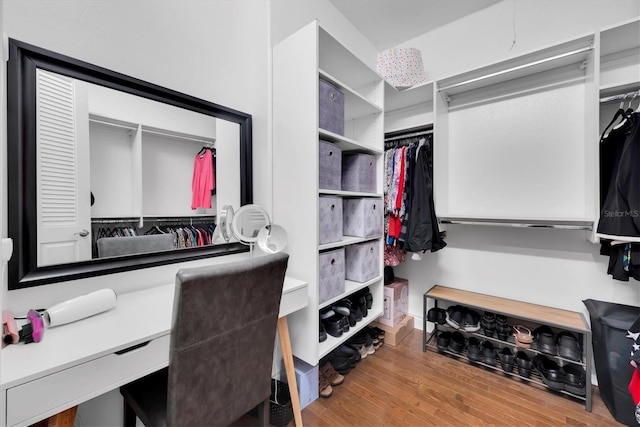 walk in closet with hardwood / wood-style floors