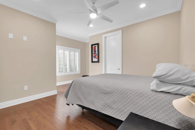 bedroom with ceiling fan, ornamental molding, a closet, and hardwood / wood-style flooring