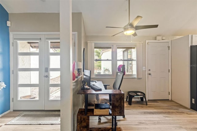 home office with ceiling fan, light wood-type flooring, and french doors