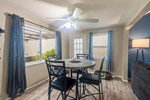 dining space featuring ceiling fan, light hardwood / wood-style flooring, and a healthy amount of sunlight