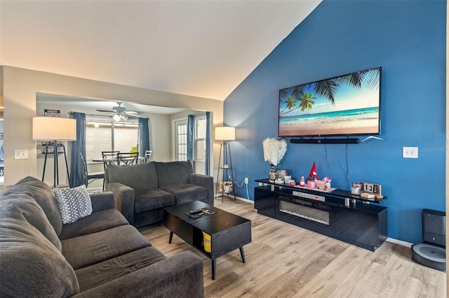 living room featuring lofted ceiling, ceiling fan, and hardwood / wood-style flooring