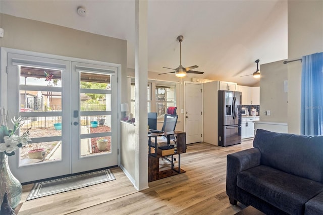 living room featuring french doors, ceiling fan, vaulted ceiling, and light hardwood / wood-style flooring