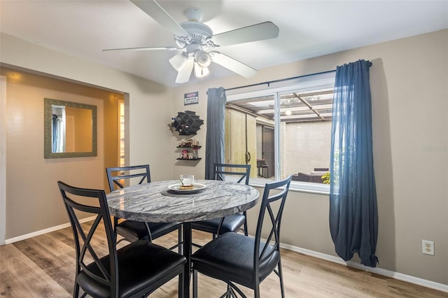 dining space with ceiling fan and hardwood / wood-style floors