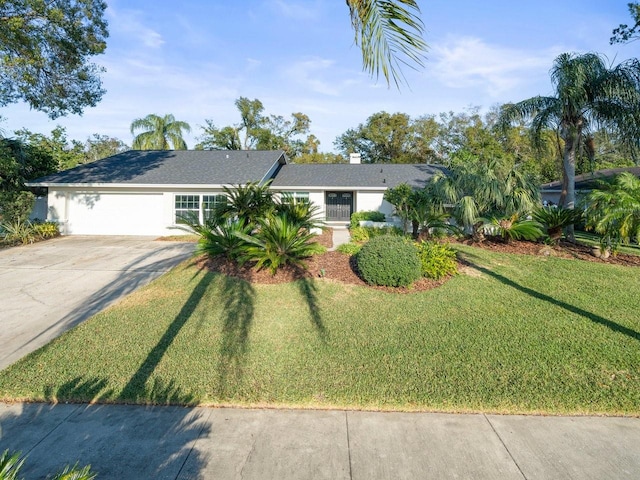 ranch-style house with a garage and a front lawn