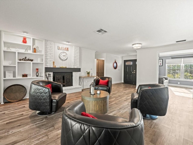 living room with a fireplace and wood-type flooring