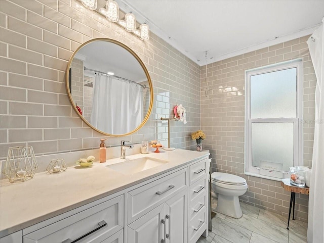 bathroom with tile walls, toilet, a shower with shower curtain, and vanity