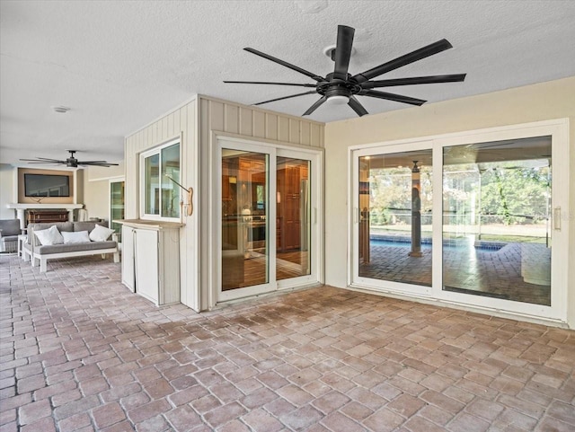 interior space with ceiling fan