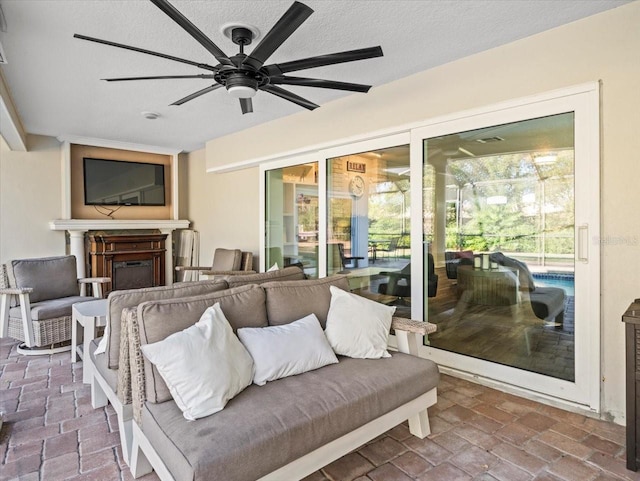 living room with a textured ceiling and ceiling fan