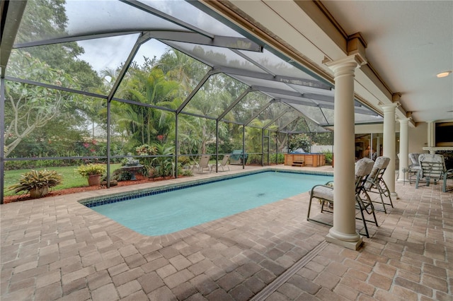 view of swimming pool featuring a lanai, a patio, and a jacuzzi