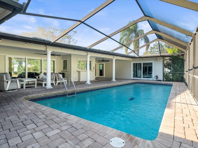 view of pool featuring ceiling fan, an outdoor hangout area, glass enclosure, and a patio area