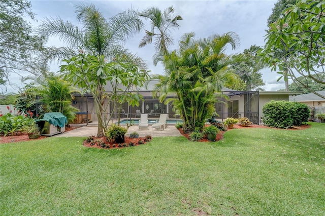 view of yard featuring a patio area and glass enclosure