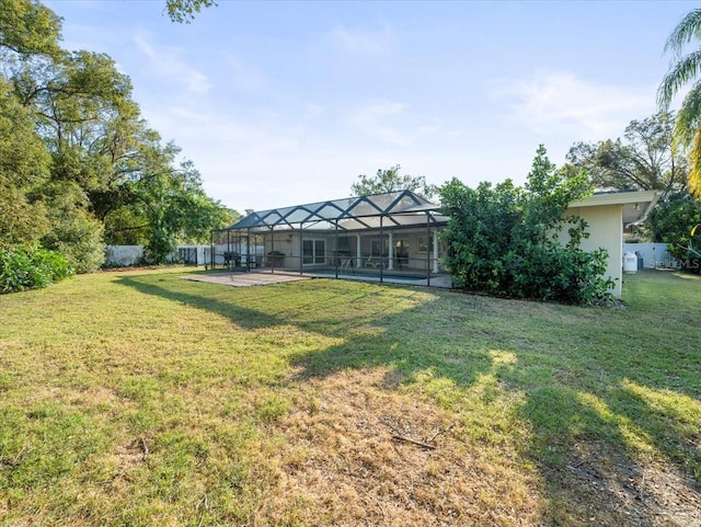 view of yard featuring a swimming pool, a lanai, and a patio area