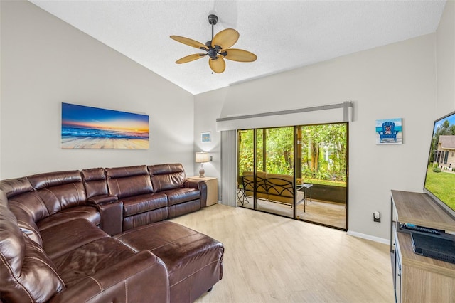 living room with ceiling fan, a textured ceiling, vaulted ceiling, and light wood-type flooring