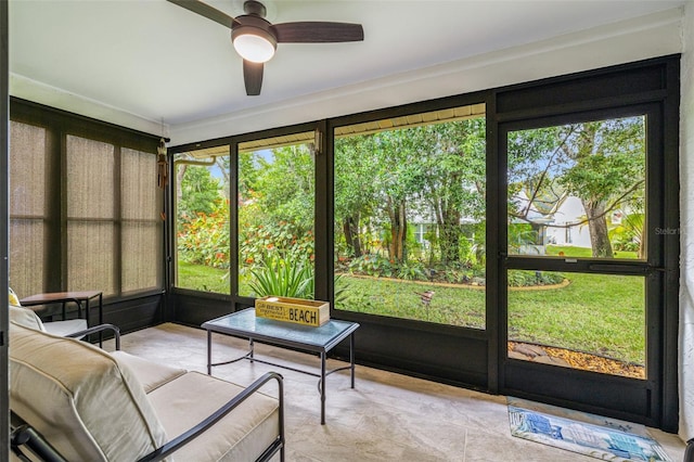 sunroom / solarium with ceiling fan and a healthy amount of sunlight