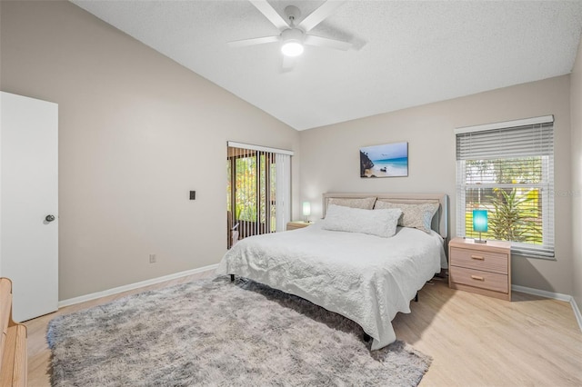 bedroom with ceiling fan, light hardwood / wood-style flooring, and vaulted ceiling