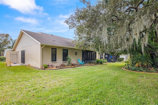 rear view of house with a yard