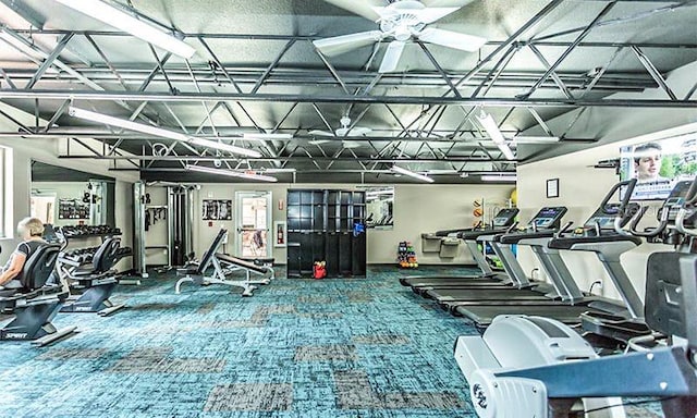 gym with ceiling fan and carpet flooring