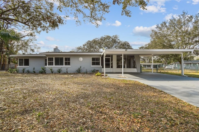 ranch-style house featuring a carport