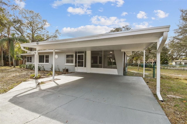 back of property with a carport