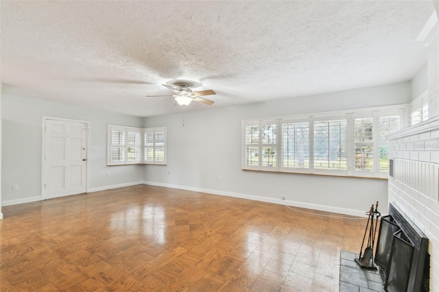 unfurnished living room with a textured ceiling and ceiling fan