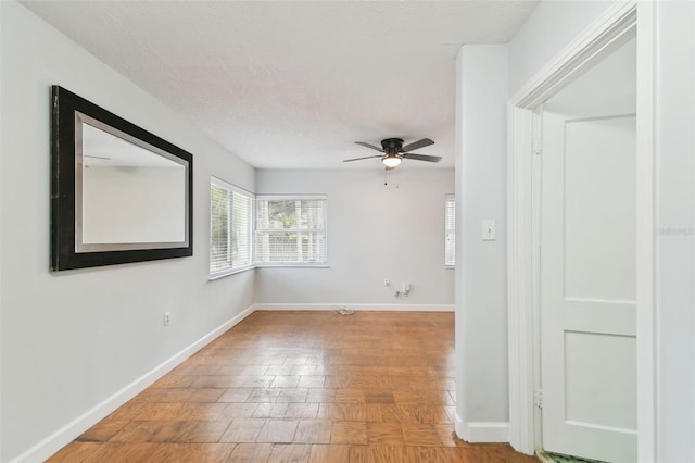 spare room with a textured ceiling and ceiling fan