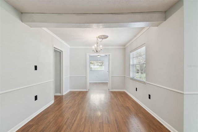 unfurnished room with beamed ceiling, an inviting chandelier, ornamental molding, and dark hardwood / wood-style flooring