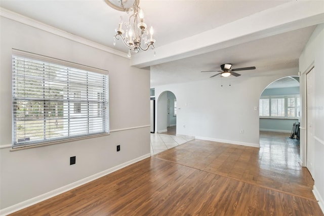 spare room with ceiling fan with notable chandelier, wood-type flooring, and beam ceiling