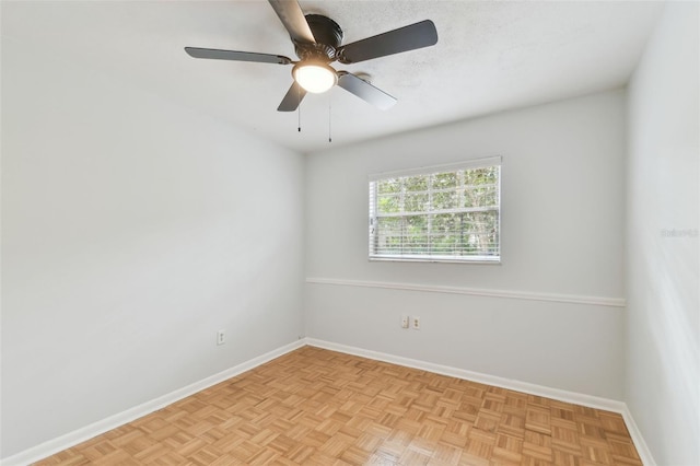 unfurnished room featuring light parquet flooring and ceiling fan