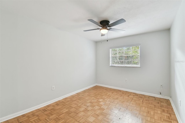 spare room featuring ceiling fan and light parquet flooring