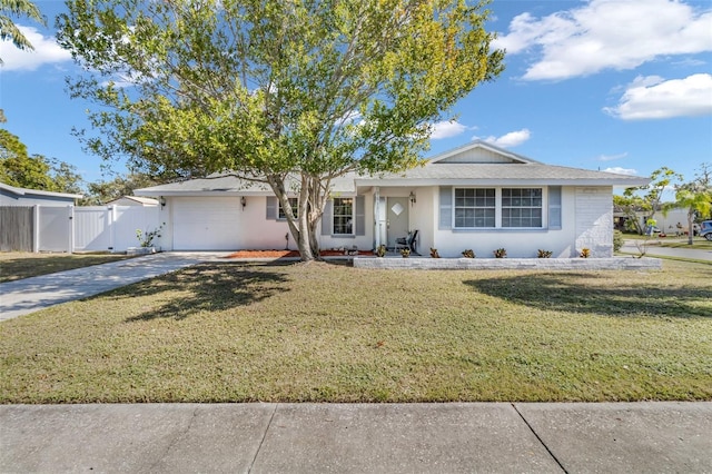 ranch-style home featuring a garage and a front yard