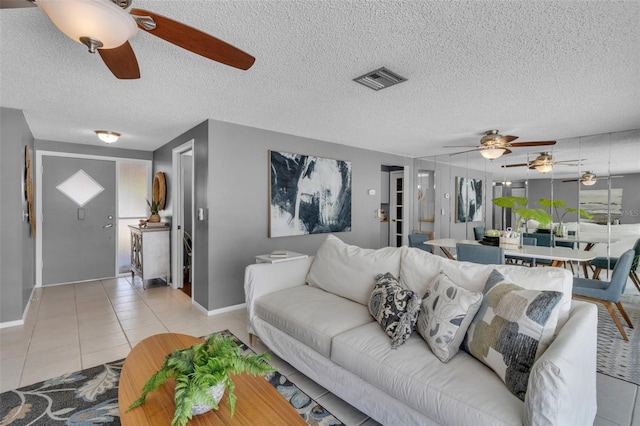 tiled living room with a textured ceiling