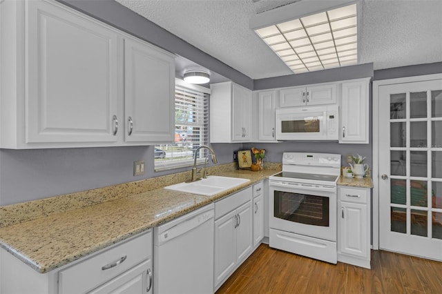 kitchen with white cabinetry, sink, white appliances, dark wood-type flooring, and a textured ceiling