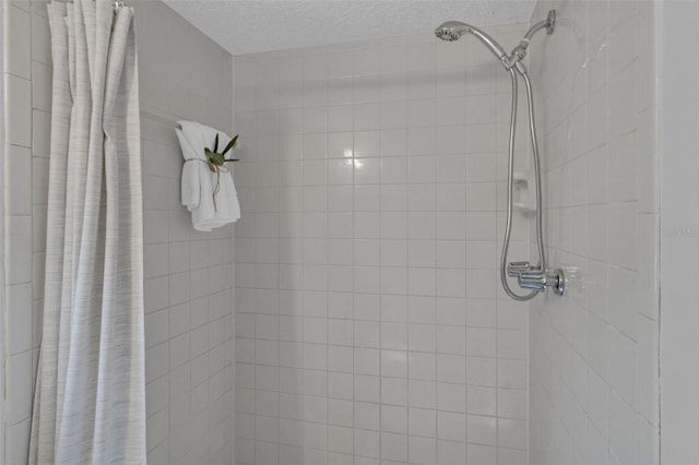 bathroom with a textured ceiling and walk in shower