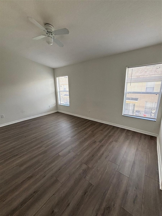 empty room featuring ceiling fan and dark hardwood / wood-style floors