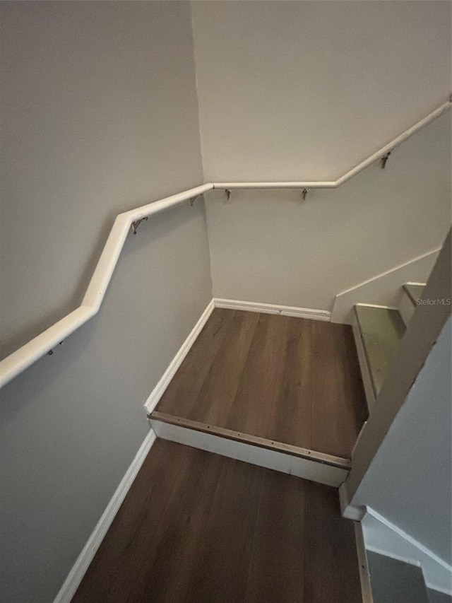 staircase featuring hardwood / wood-style floors