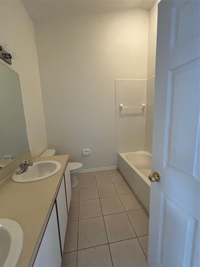 bathroom with toilet, tile patterned flooring, and vanity